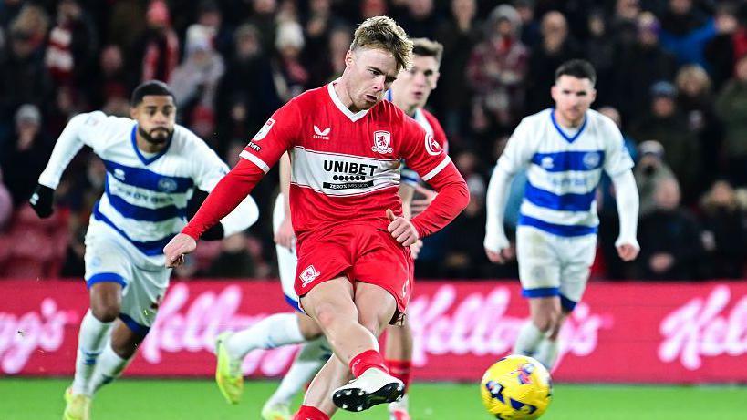 Tommy Conway strokes his penalty with his right foot as three QPR players look on behind him 