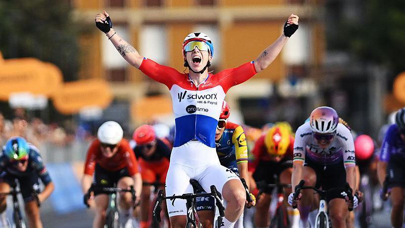 Lorena Wiebes celebrates as she crosses the finish line