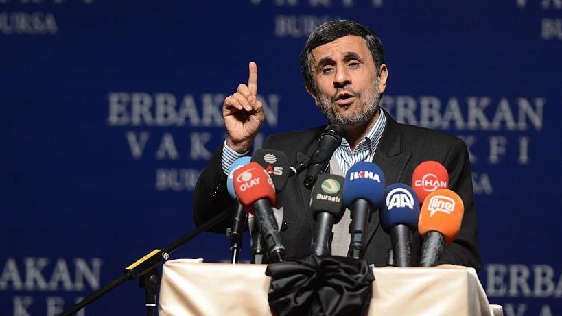 Former Iranian President Mahmoud Ahmadinejad makes a speech in front of a podium in 2015.