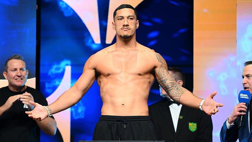 Jai Opetaia raises his hands after weighing in for a fight