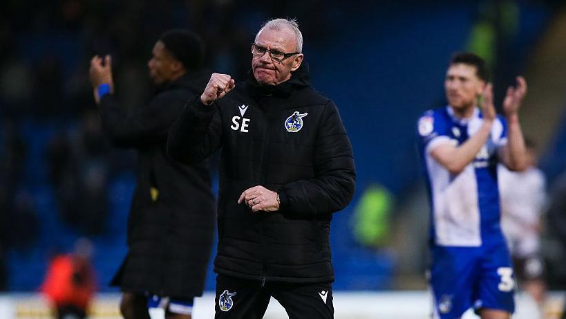 Bristol Rovers manager Steve Evans celebrates with a clenched fist
