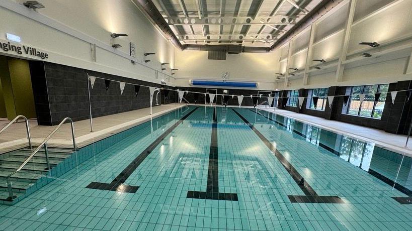 A four-lane swimming pool at the Station Leisure and Learning Centre, with bunting hanging above the pool 