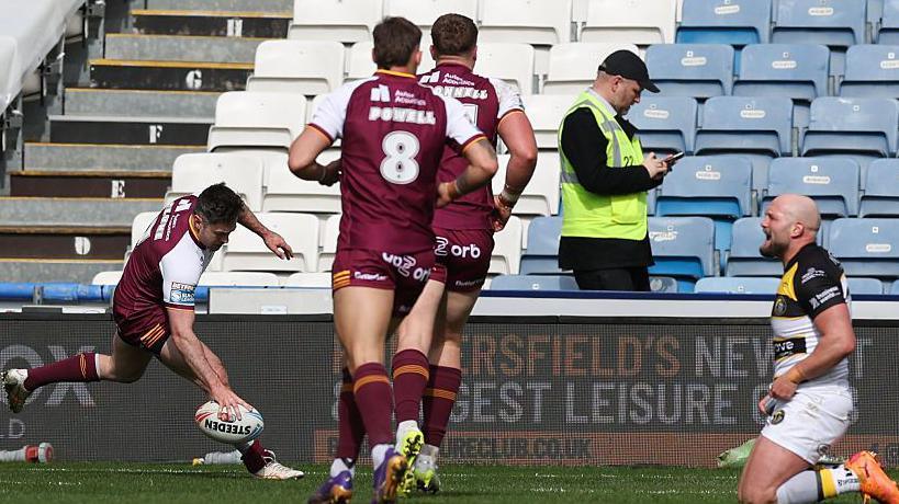 Adam Clune of Huddersfield scores a try