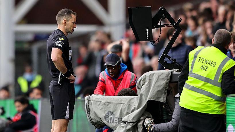 Jarred Gillett at the pitchside monitor for a VAR review in the game between Crystal Palace and Bournemouth