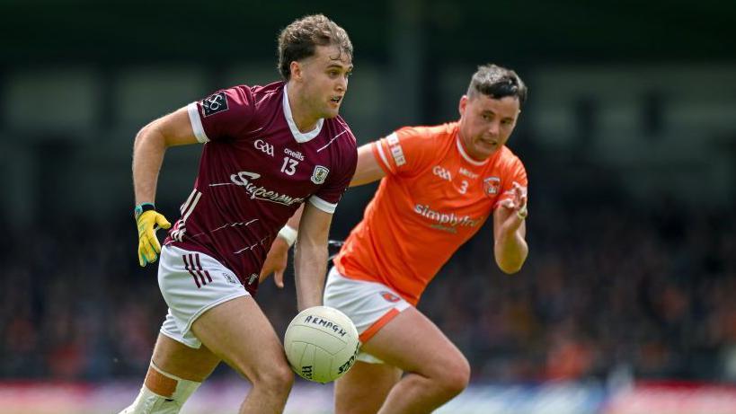 Rob Finnerty runs with the ball against Armagh