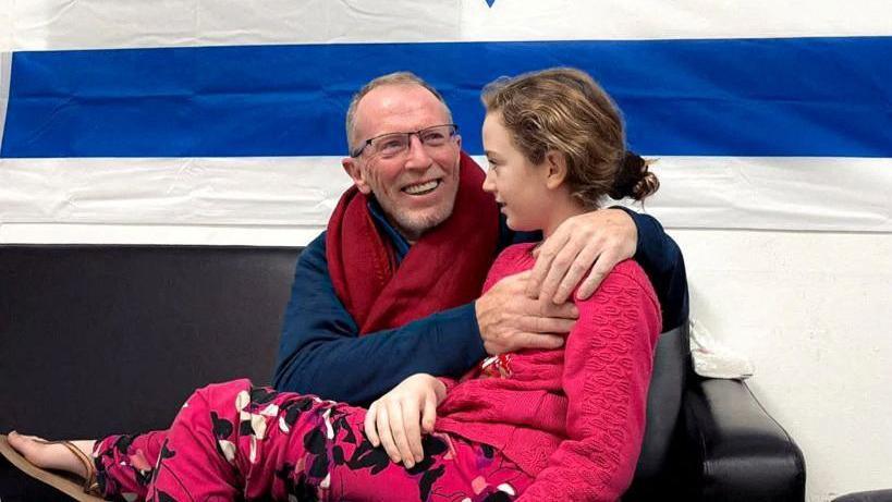 Thomas and Emily Hand embracing after her release