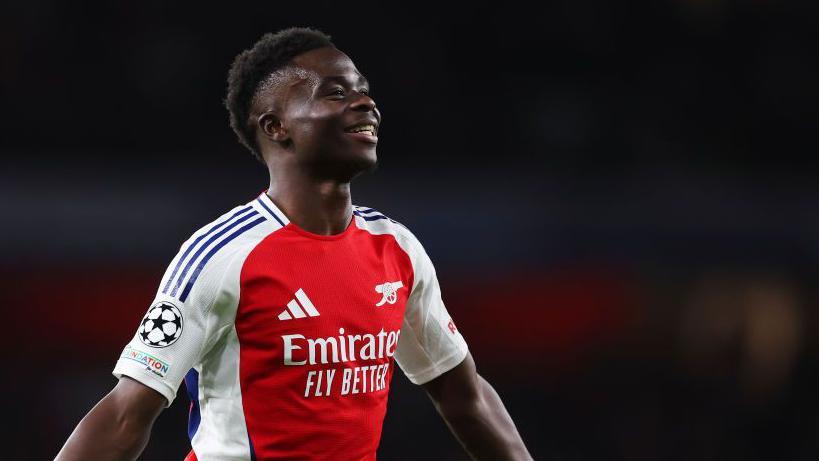 Bukayo Saka celebrates scoring in the Champions League 