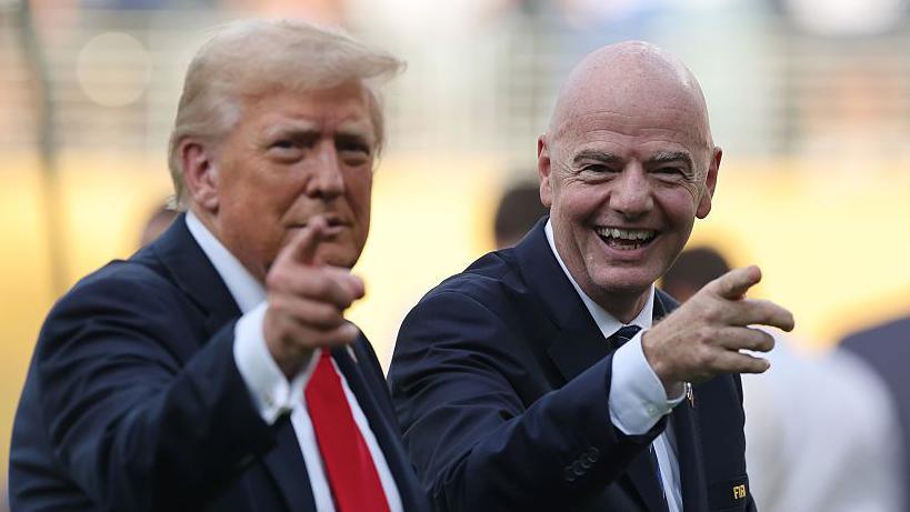 US President Donald Trump and a smiling Fifa president Gianni Infantino point at the camera after the Club World Cup final