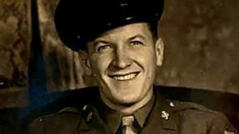 Andrew Piter in uniform, including a hat, smiling. The picture is a sepia colour.
