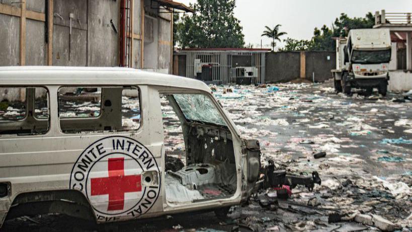 Destroyed International Committee of the Red Cross (ICRC) vehicles lie amid debris at a looted World Food Programme warehous