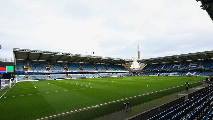 A view of Millwall FC stadium The Den from the side of the pitch in the lower tier of the stands.