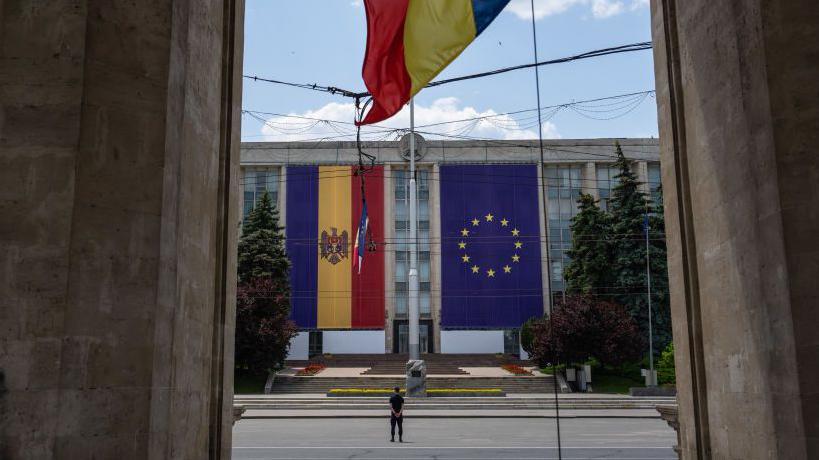 Giant Moldovan and EU flags hanging at the main government building in the country's capital Chisinau