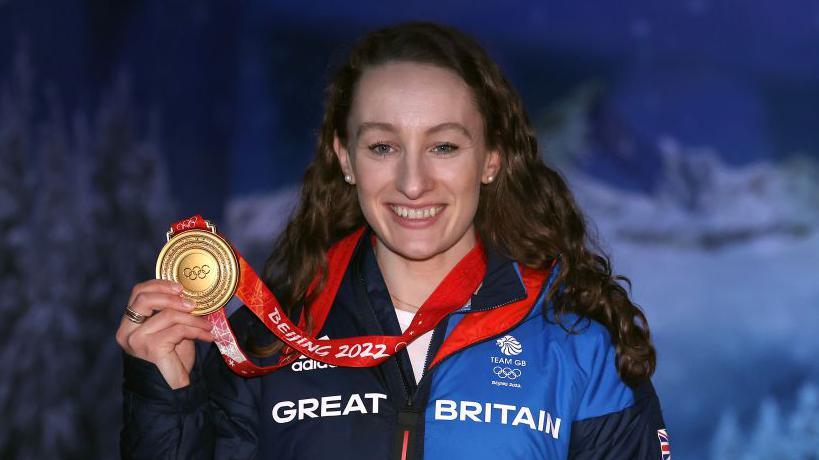 Jennifer Dodds shows off her Olympic gold medal at Beijing 2022