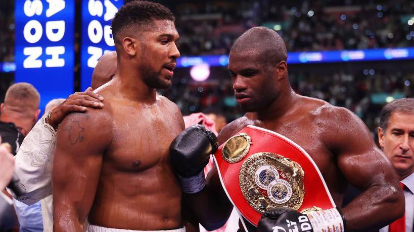 Anthony Joshua is consoled by Daniel Dubois