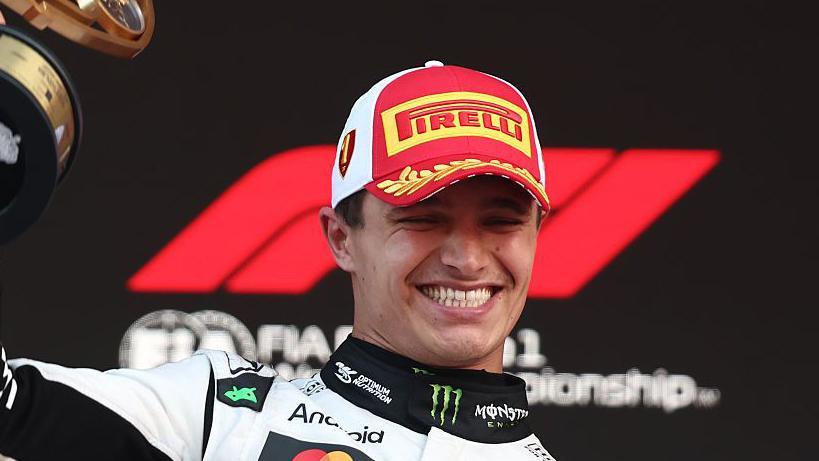 Lando Norris smiling on the podium in Monaco