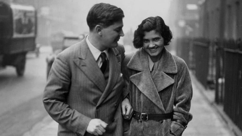 Black and white image of Aneurin Bevan walking with Jennie Lee.