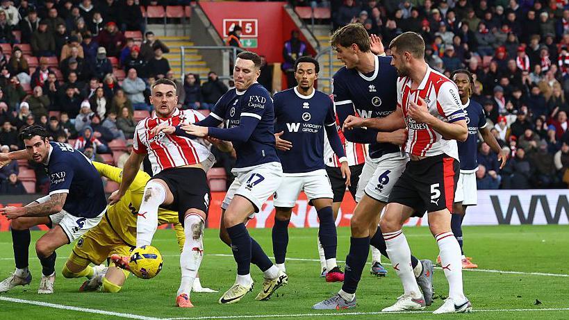 Taylor Harwood-Bellis clears the ball in the area