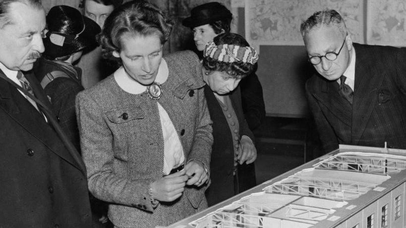 Lady Allen inspects a model of a children's nursery 