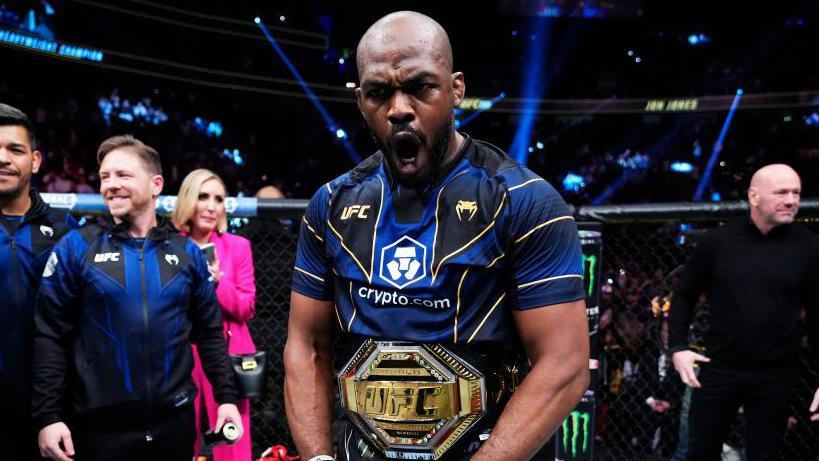 Jon Jones celebrates winning the UFC heavyweight title at UFC 285 in March 2023