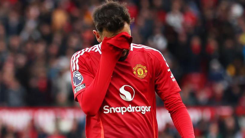 Manchester United captain Bruno Fernandes departs in despair after his red card against Spurs