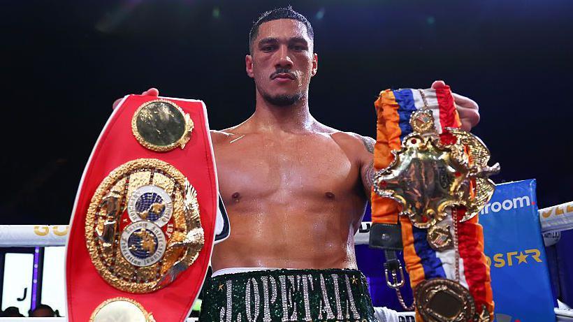 Jai Opetaia holding his belts