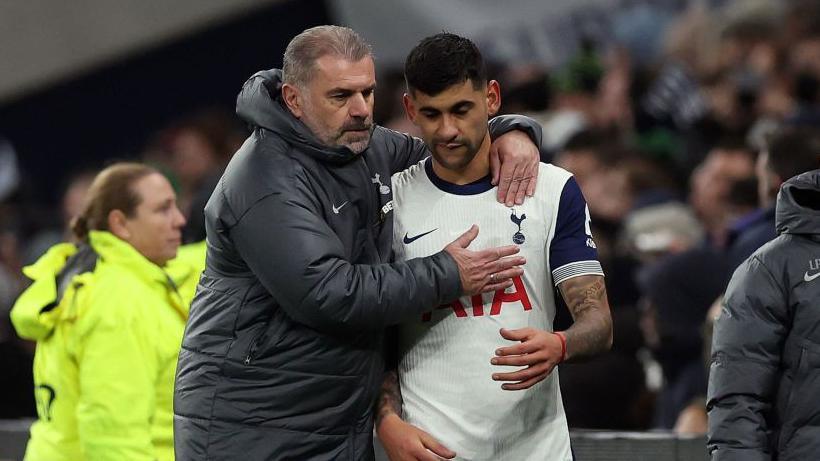 Tottenham manager Ange Postecoglou with defender Cristian Romero