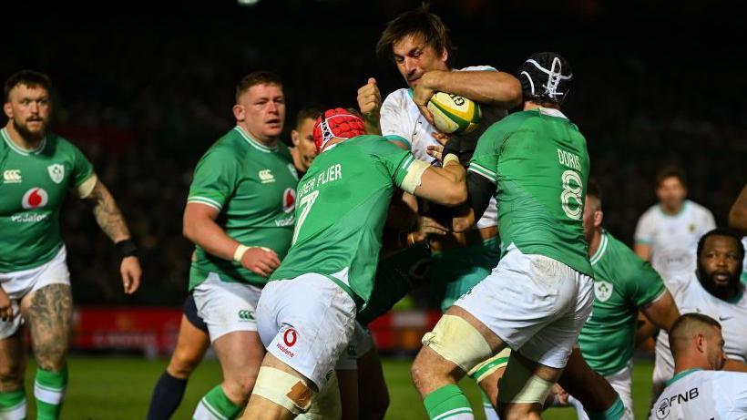 Springbok Eben Etzebeth is tackled by Ireland players