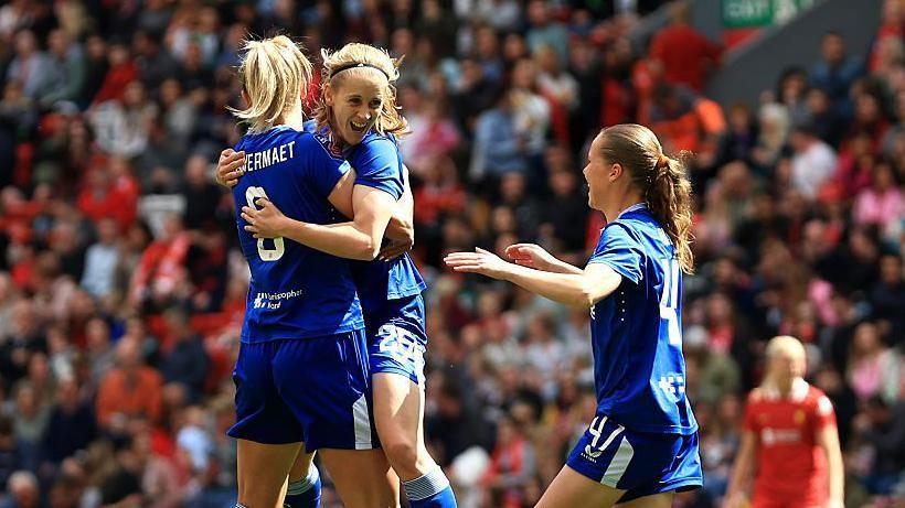 Everton players celebrate with Katja Snoeijs after her opener at Anfield