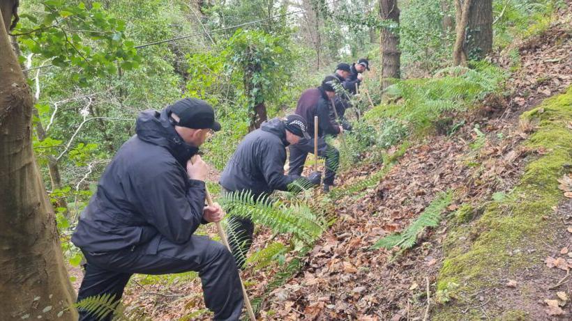 Teams scouring woodland in connection with Richard Scatchard