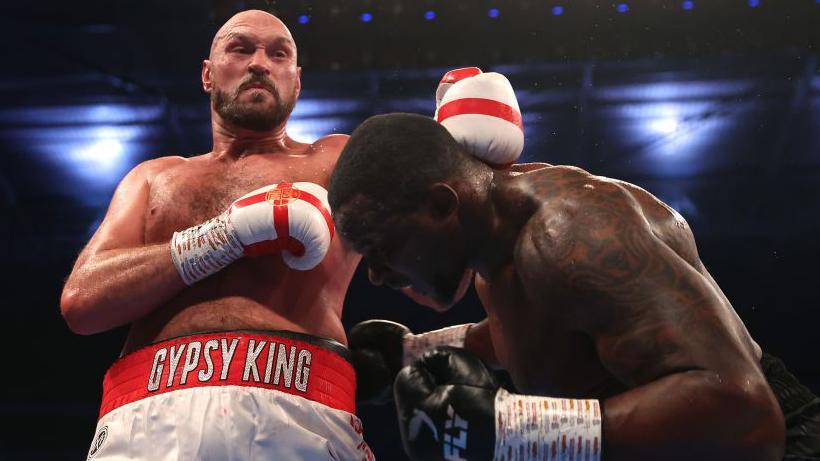 Tyson Fury punches Dillian Whyte during their fight