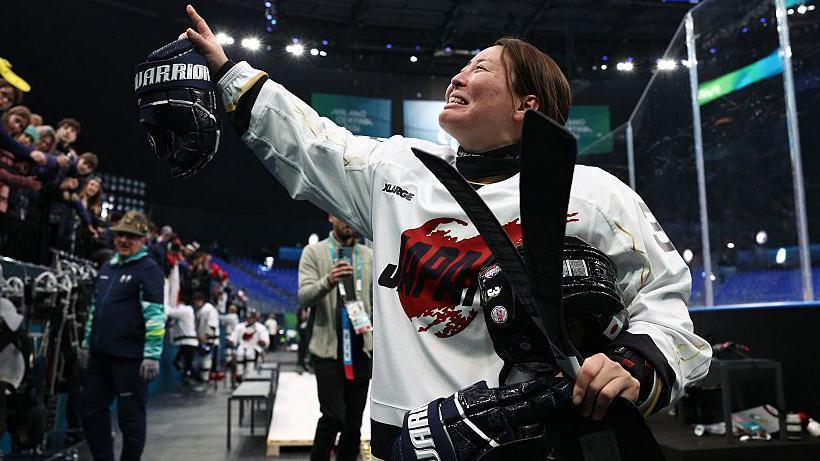 Akari Fukunishi greets the crowd at Milan-Cortina in Japan's match against Czechia