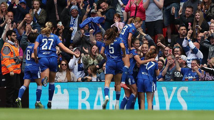 Everton players celebrate in front of their away fans at Anfield