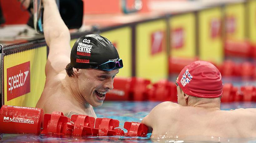 Matt Richards celebrates in the pool with Duncan Scott