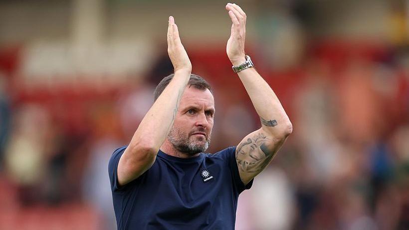 Nathan Jones applauds Charlton fans at Cheltenham