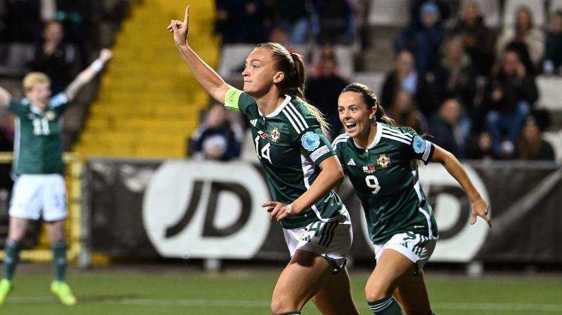 Lauren Wade celebrates scoring on her 50th cap