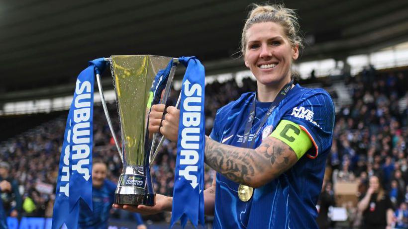 Millie Bright lifts the Women's League Cup trophy