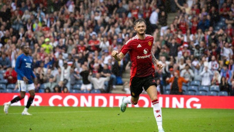 Joe Hugill celebrates scoring for Manchester United at Glasgow Rangers