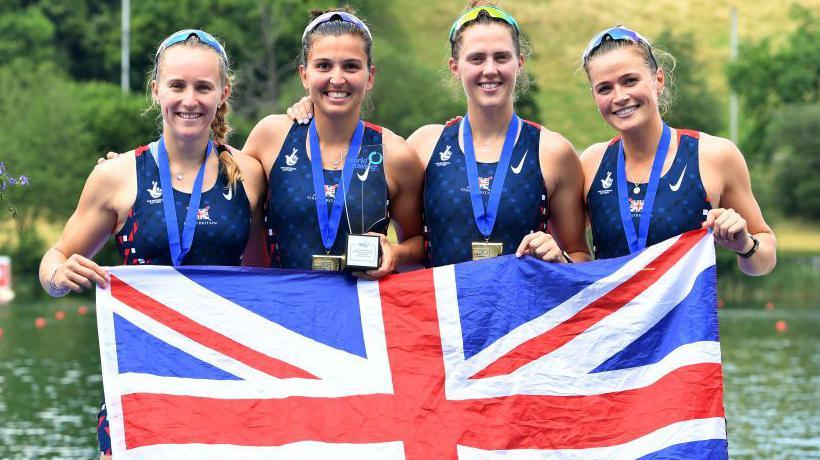 Heidi Long, Rowan Mckellar, Samantha Redgrave, Rebecca Shorten pose with a British flag