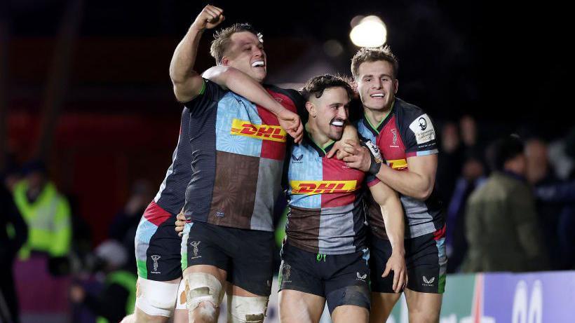 Alex Dombrandt [right], Cadan Murley [centre] and Oscar Beard [right] celebrate after Murley scores a try for Harlequins