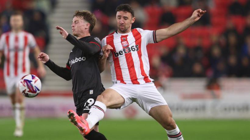 Stoke defender Enda Stevens tackling George Tanner