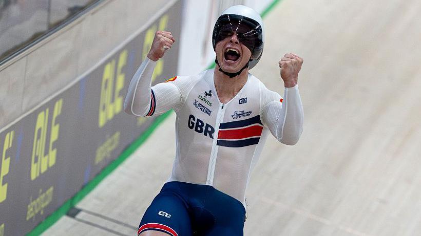 Matt Richardson celebrates on a bike in the velodrome