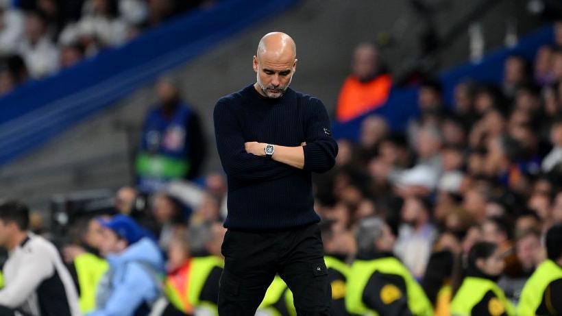 Pep Guardiola, Manager of Manchester City, looks dejected