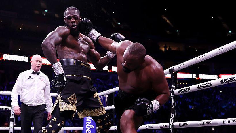 Deontay Wilder is punched by Derek Chisora