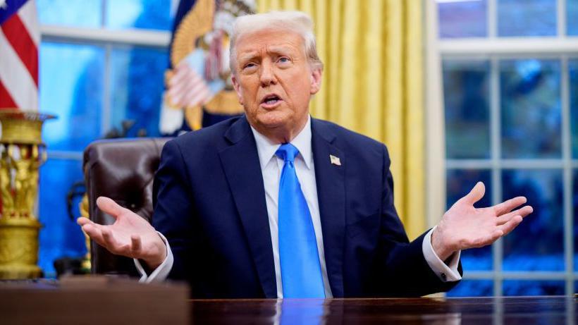 US President Donald Trump sitting in the Oval Office in Washington