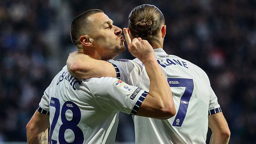 Milutin Osmajic celebrates with Will Keane