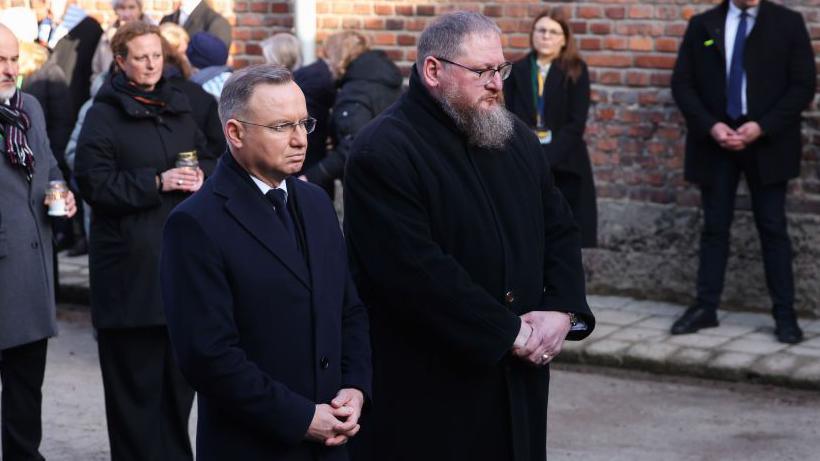 Polish President Andrzej Duda and Piotr Cywinski, Auschwitz Museum director, pay homage at 'The Death Wall' during the 80th anniversary of the liberation of Auschwitz at Memorial and Museum Auschwitz-Birkenau former Nazi-German concentration and extermination camp