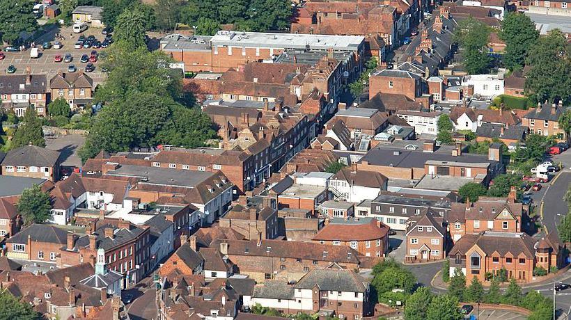 An aerial shot of Godalming, which is predominantly red brick buildings. 