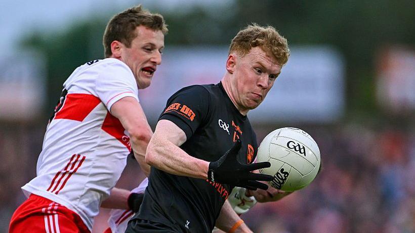 Derry's Brendan Rogers in action against Conor Turbitt of Armagh