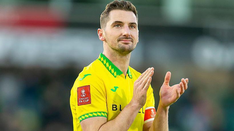 Norwich City captain Kenny McLean applauds