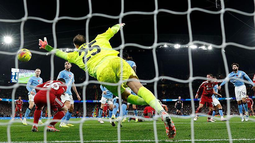 Virgil van Dijk of Liverpool scores past Gianluigi Donnarumma of Manchester City but the effort is ruled out for offside against Andrew Robertson